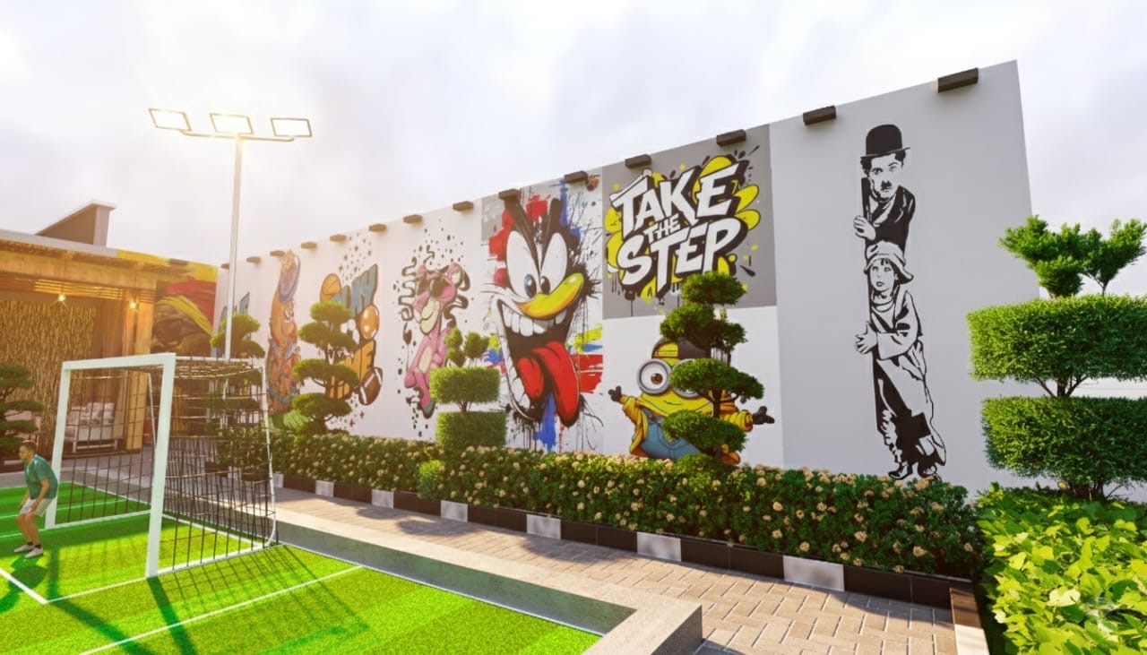Football court with a mural wall, shaped trees and a planted border